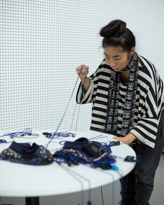 Performer in motion capture sensors during Dancing at the Edge of the World rehearsal