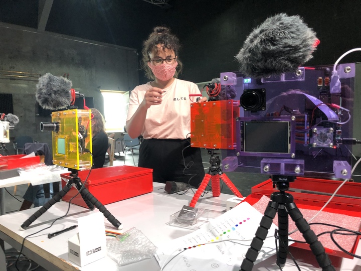 Performer interacting with AI-driven interface during Regie: KI performance